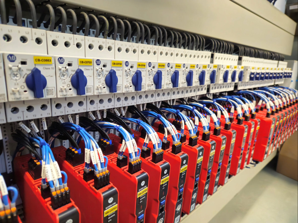 Row of Allen-Bradley 140MT motor protection circuit breakers in a Mosaix Mechanical control panel