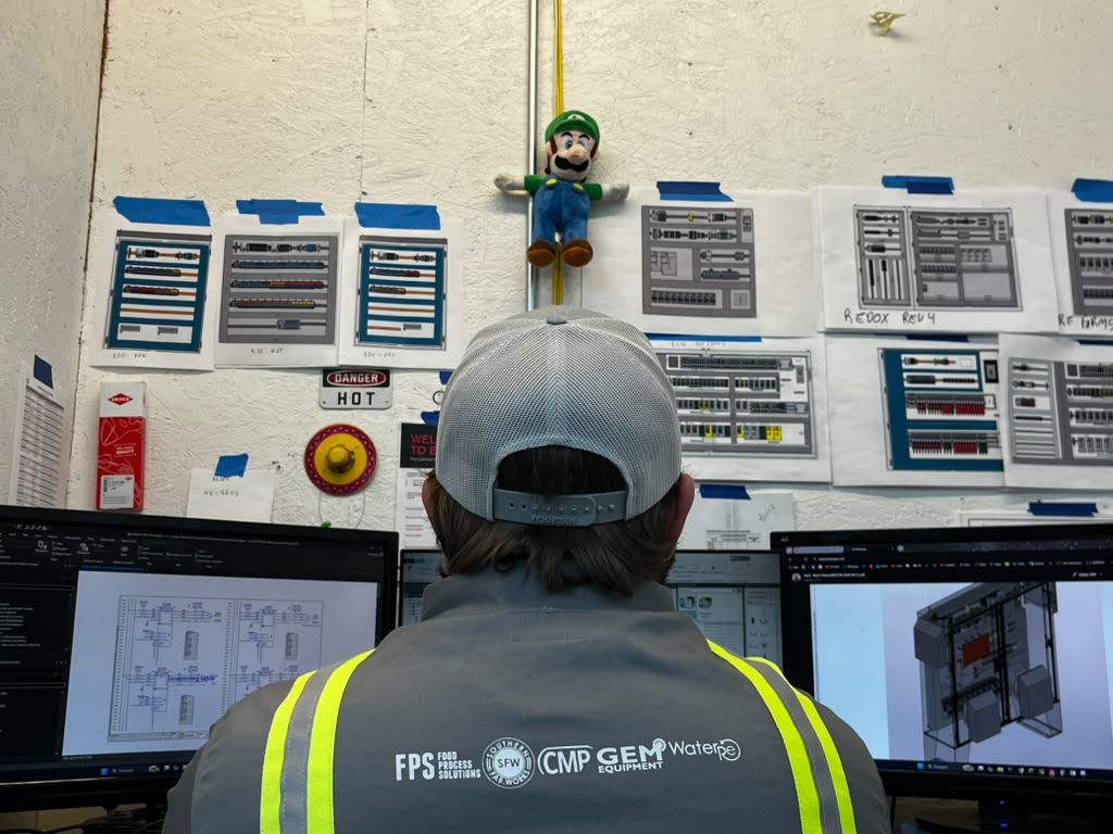 Mosaix Mechanical engineer drawing an industrial control panel schematic in CAD electrical design software