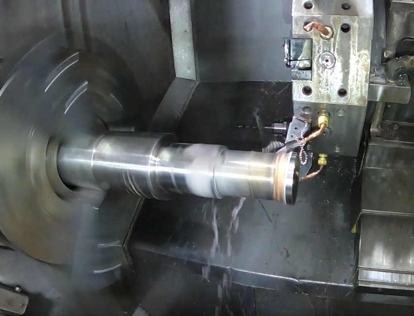 Stepped shaft being turned on a CNC lathe at Mosaix Mechanical