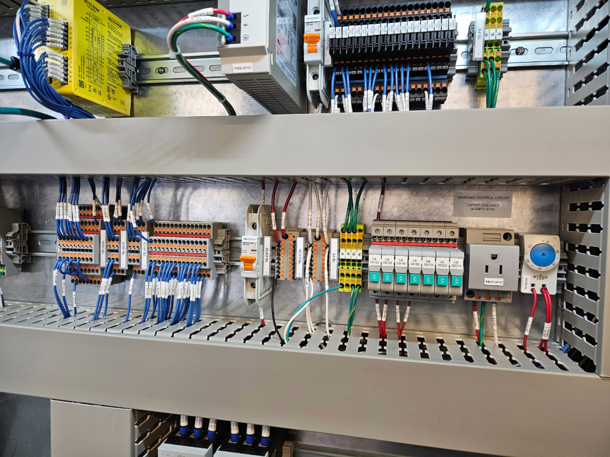 Terminal blocks, breakers and numbered wiring inside a Mosaix Mechanical control panel