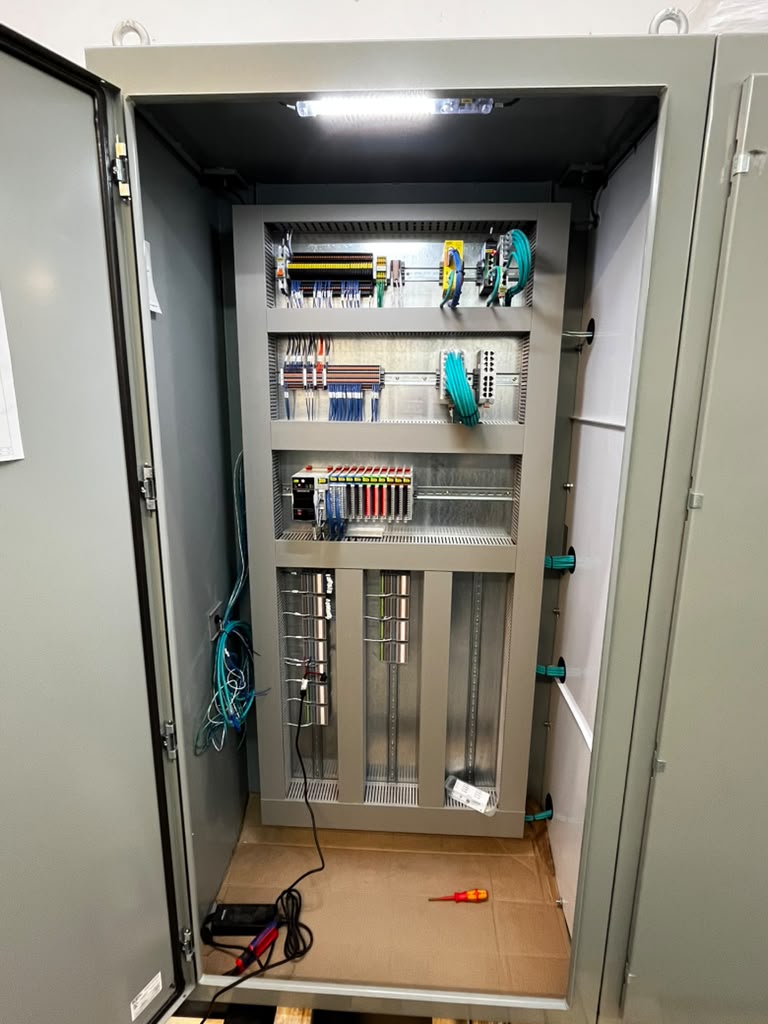 Components mounted and laid out inside an open Mosaix Mechanical industrial control panel enclosure