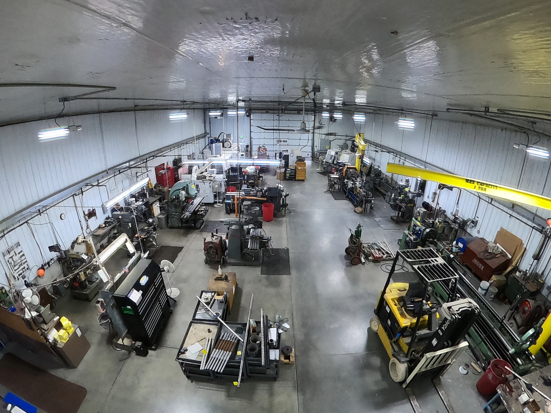 The Mosaix Mechanical machine shop floor in Burley, Idaho with engine lathes, milling machines, bar stock and a one-ton overhead jib crane