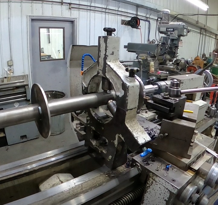 Long shaft set up in a steady rest on a manual lathe at Mosaix Mechanical
