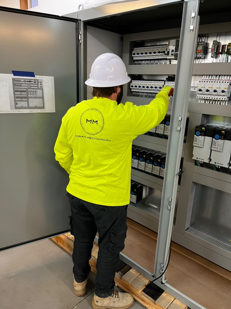 Mosaix Mechanical crew installing a motor control and VFD panel at an industrial plant