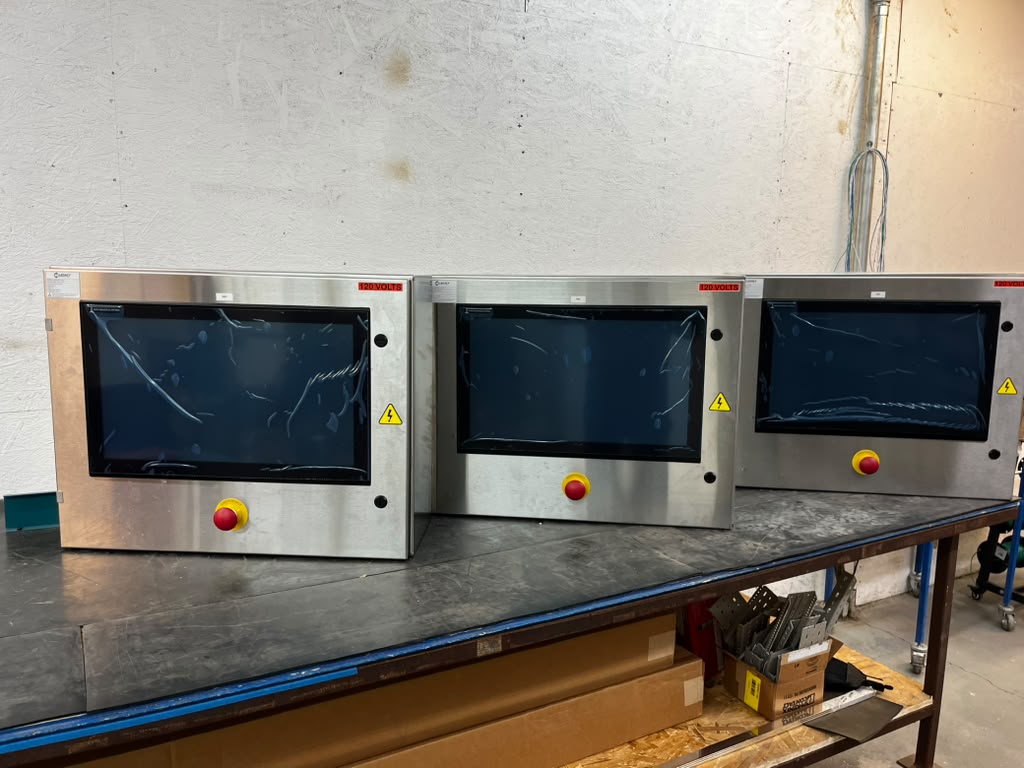 Stainless steel HMI touchscreen operator enclosures for a washdown food processing line
