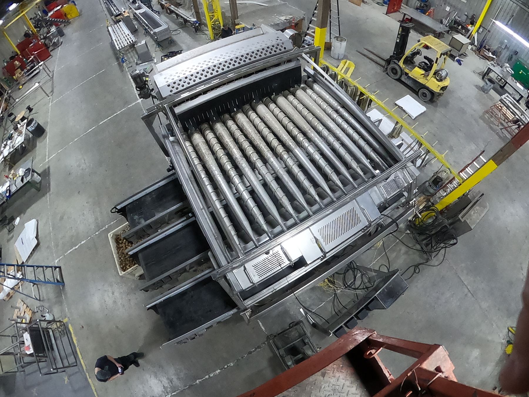 Stainless steel roller grading table built by Mosaix Mechanical for potato handling in an Idaho processing plant
