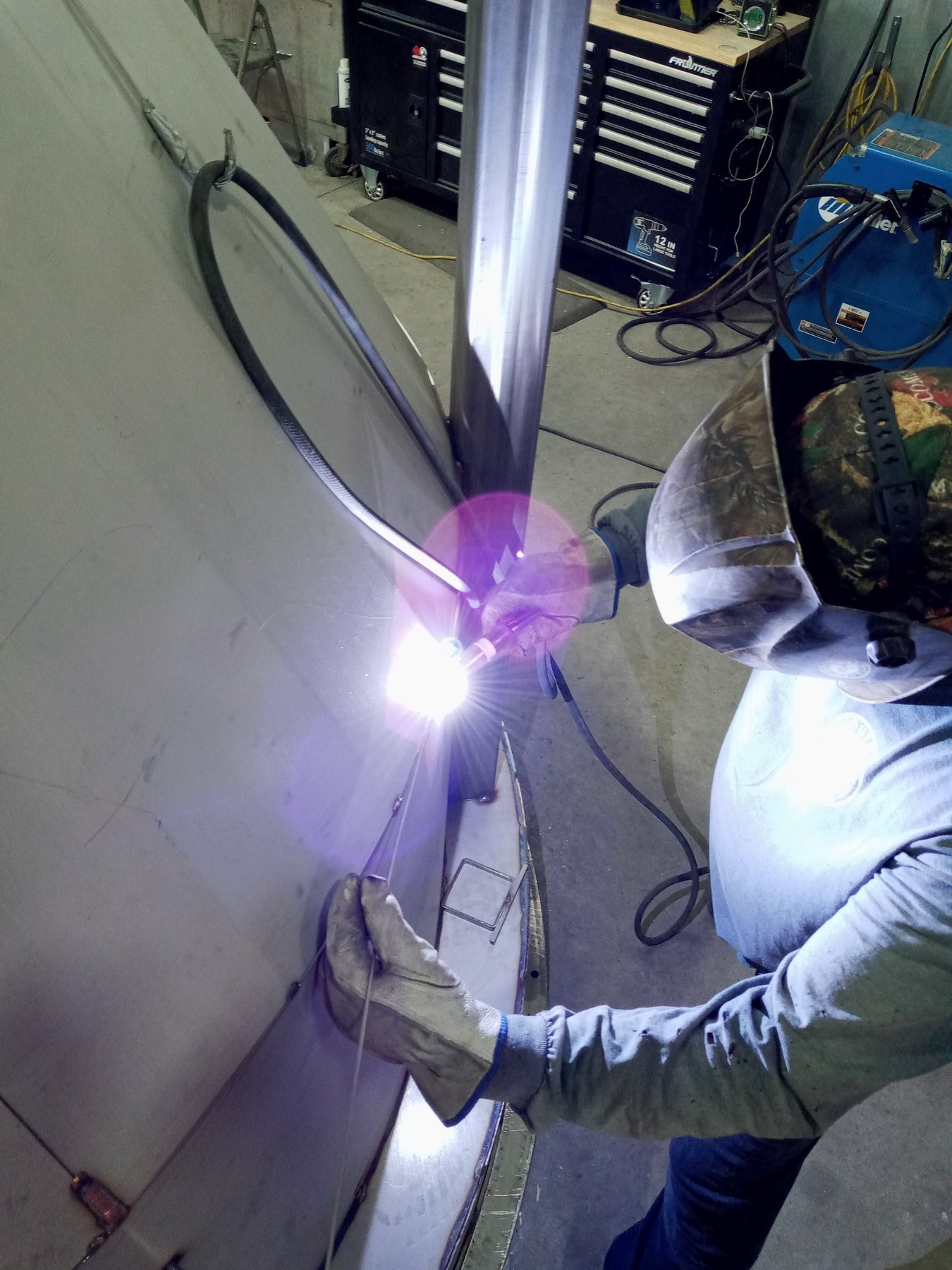 Welder TIG welding a vertical seam on a large stainless steel tank at Mosaix Mechanical in Burley, Idaho